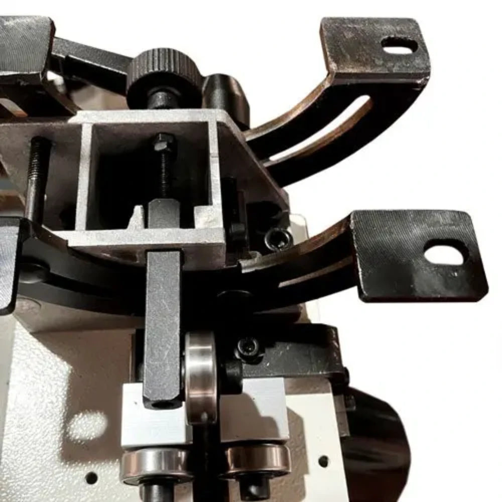 Lower blade guide bearings and tension bracket under the table