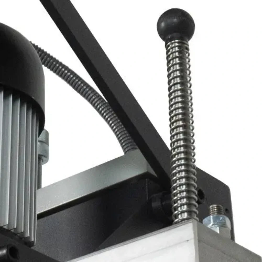 Spring-loaded hold-down foot keeps workpiece stable during drilling