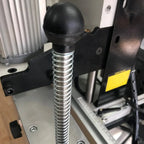 Return spring mechanism on drill carriage for smooth vertical travel