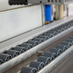 Full-length roller conveyor supports panels during edge banding work