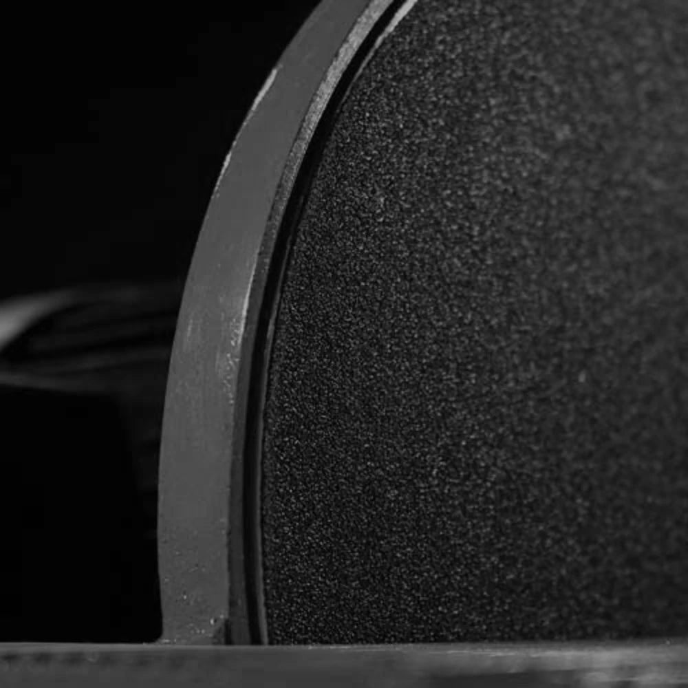 Close-up of textured sanding disc and guard on benchtop sander