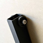 Detail of padded roller wheel on vertical panel support arm